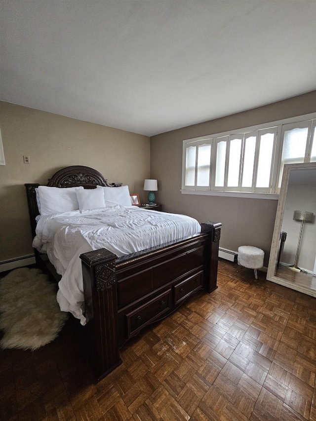 bedroom featuring baseboard heating and dark parquet flooring