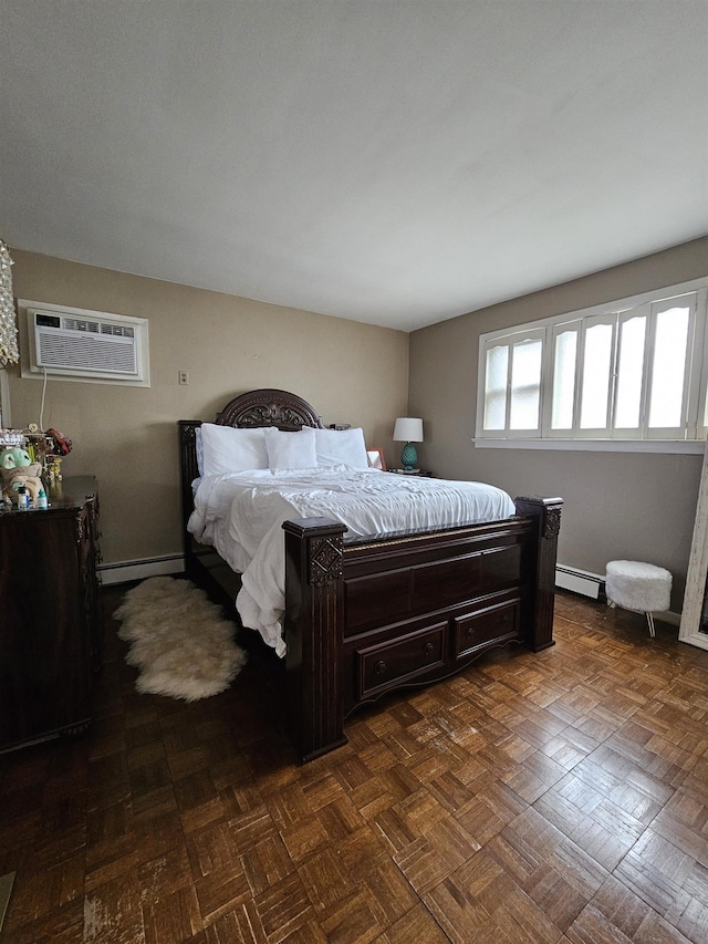 bedroom featuring a wall mounted air conditioner, dark parquet flooring, and baseboard heating