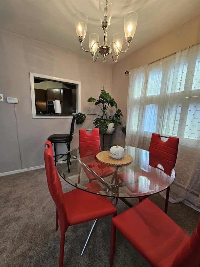 carpeted dining space featuring a chandelier