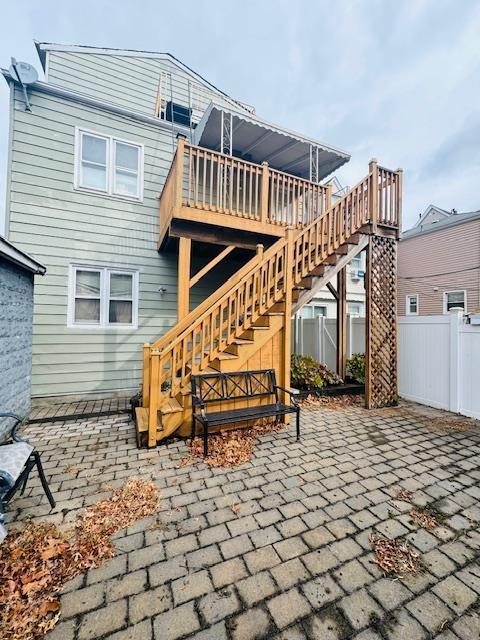 back of property with a patio and a deck