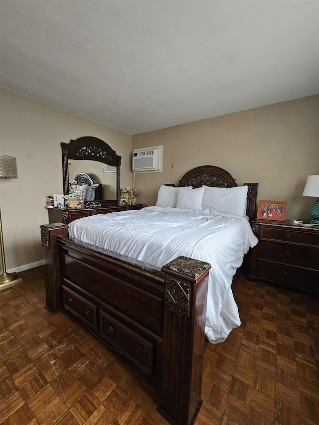 bedroom with dark parquet floors and a wall mounted AC