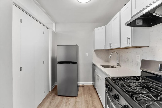 1225 Kennedy Blvd Unit 9H, Bayonne, NJ 07002 - kitchen featuring stainless steel appliances, extractor fan, light wood-type flooring, white cabinetry, and light countertops