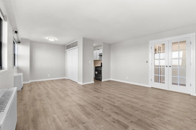 1225 Kennedy Blvd Unit 9H, Bayonne, NJ 07002 - unfurnished living room with light wood-style floors and french doors