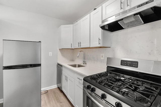 1225 Kennedy Blvd Unit 9H, Bayonne, NJ 07002 - kitchen with stainless steel appliances, exhaust hood, light countertops, and white cabinets