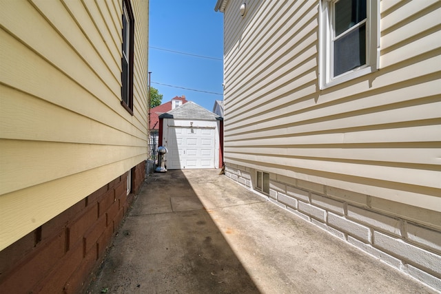 159 W 33rd St, Bayonne, NJ 07002 - view of property exterior with an outbuilding, concrete driveway, and a detached garage