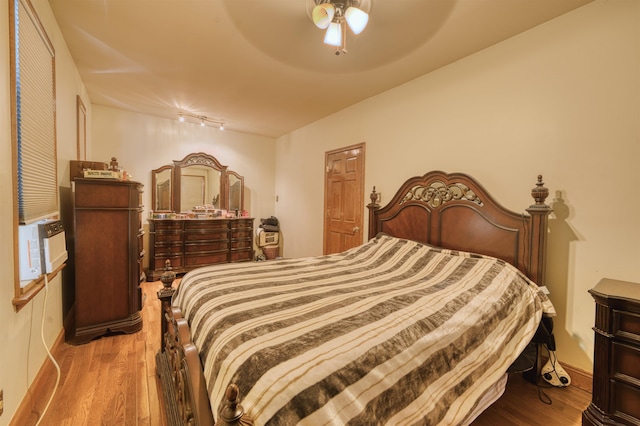 159 W 33rd St, Bayonne, NJ 07002 - bedroom with wood finished floors, track lighting, a ceiling fan, and cooling unit