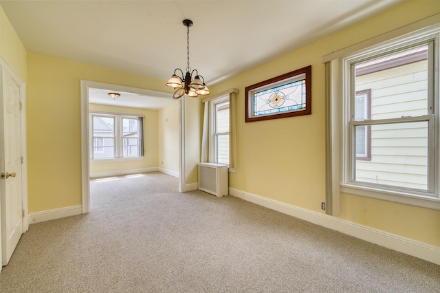 159 W 33rd St, Bayonne, NJ 07002 - spare room with light carpet, a chandelier, and baseboards