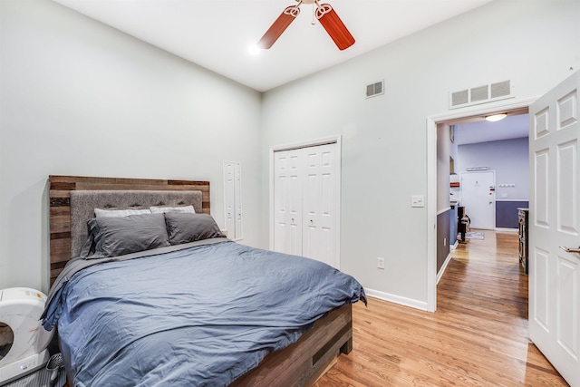 bedroom with light wood-style flooring, a closet, visible vents, and baseboards