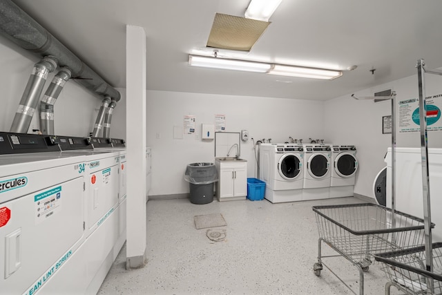 shared laundry area featuring separate washer and dryer and baseboards