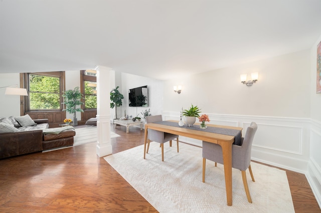 83 Montgomery St Unit 201, Jersey City, NJ 07302 - dining room featuring decorative columns, wainscoting, and wood finished floors