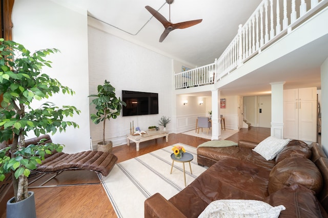83 Montgomery St Unit 201, Jersey City, NJ 07302 - living area with ornate columns, high vaulted ceiling, a ceiling fan, wood finished floors, and wainscoting
