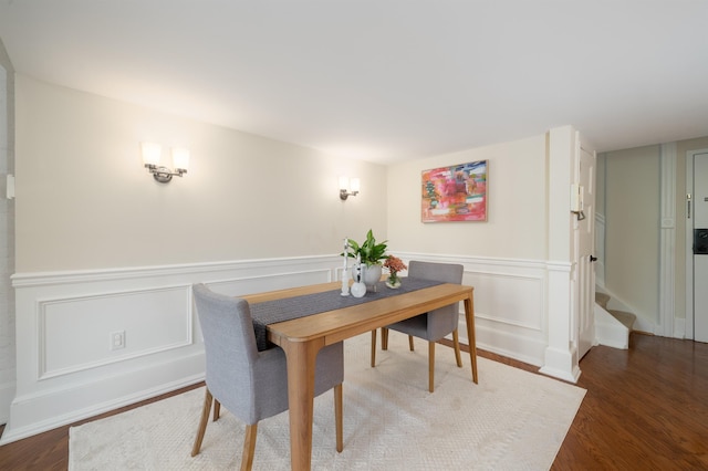 83 Montgomery St Unit 201, Jersey City, NJ 07302 - dining space with a decorative wall, wood finished floors, and a wainscoted wall
