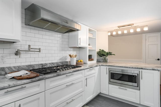 83 Montgomery St Unit 201, Jersey City, NJ 07302 - kitchen featuring ventilation hood, stainless steel appliances, white cabinetry, and tasteful backsplash