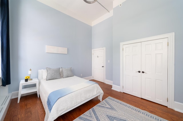 83 Montgomery St Unit 201, Jersey City, NJ 07302 - bedroom with high vaulted ceiling, a closet, and wood finished floors