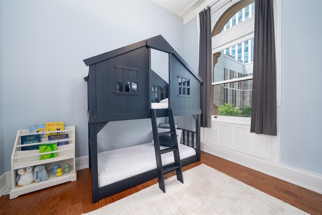83 Montgomery St Unit 201, Jersey City, NJ 07302 - bedroom featuring multiple windows and wood finished floors