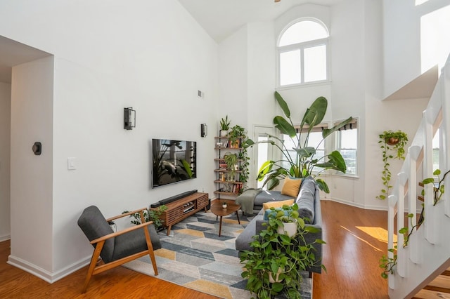 4313 Smith Ave Unit 10, North Bergen, NJ 07047 - living area with high vaulted ceiling, wood finished floors, baseboards, and stairs