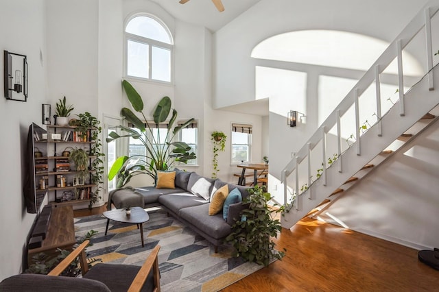 4313 Smith Ave Unit 10, North Bergen, NJ 07047 - living room featuring a towering ceiling, wood finished floors, stairs, and healthy amount of natural light