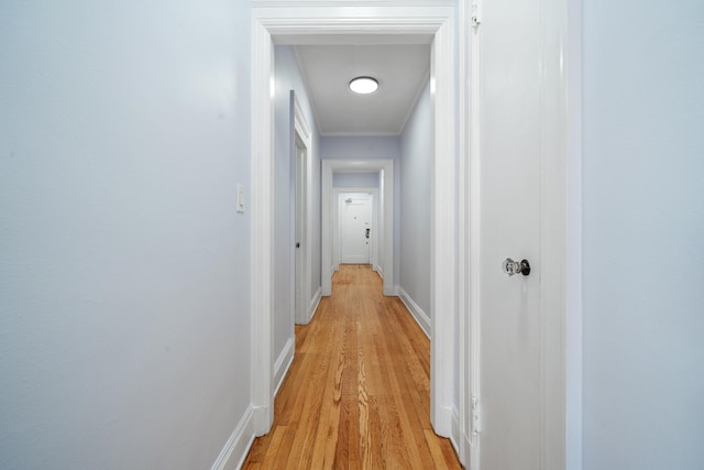 corridor with light hardwood / wood-style flooring