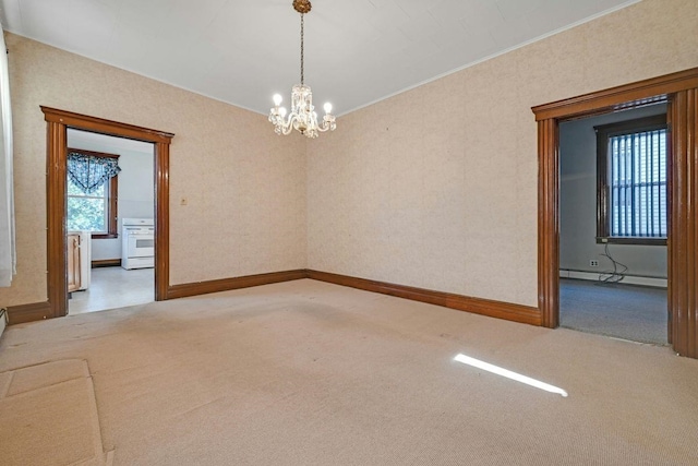 carpeted empty room with a baseboard heating unit, ornamental molding, baseboards, and a chandelier