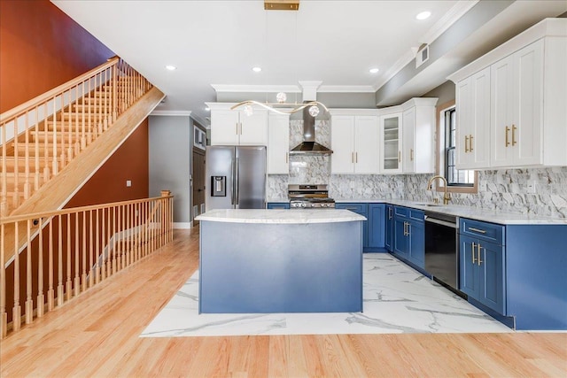 412 10th St Unit 2, Union City, NJ 07087 - kitchen with wall chimney range hood, appliances with stainless steel finishes, visible vents, blue cabinetry, and ornamental molding