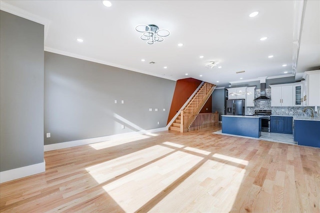 412 10th St Unit 2, Union City, NJ 07087 - unfurnished living room featuring recessed lighting, ornamental molding, light wood-type flooring, and stairway