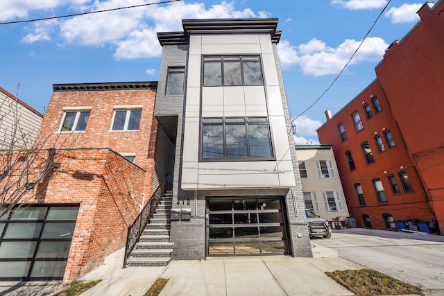412 10th St Unit 2, Union City, NJ 07087 - view of front of house with brick siding and an attached garage