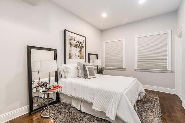 bedroom with dark hardwood / wood-style floors