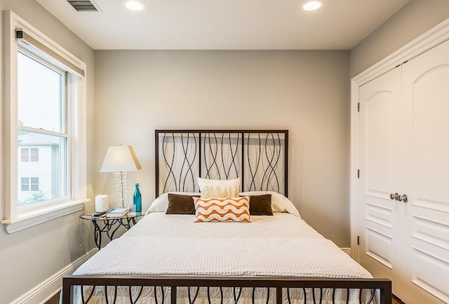 bedroom featuring a closet and multiple windows