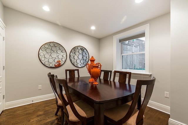 dining space with dark wood-type flooring