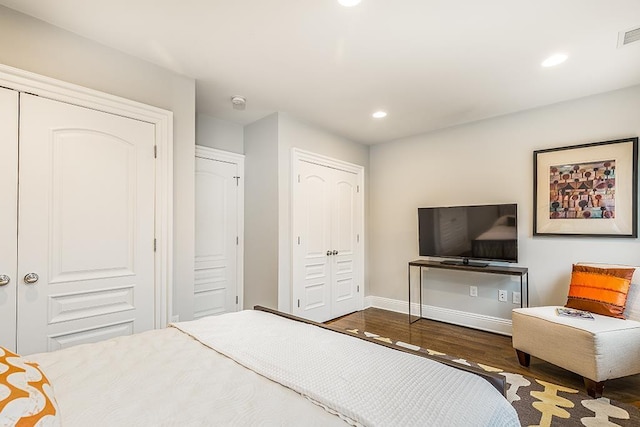 bedroom with dark hardwood / wood-style flooring