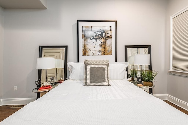 bedroom with dark hardwood / wood-style floors