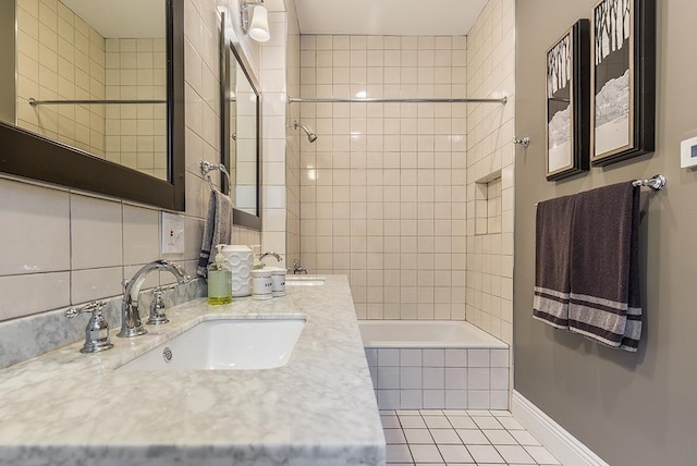 bathroom featuring tile patterned floors, vanity, and tiled shower / bath combo