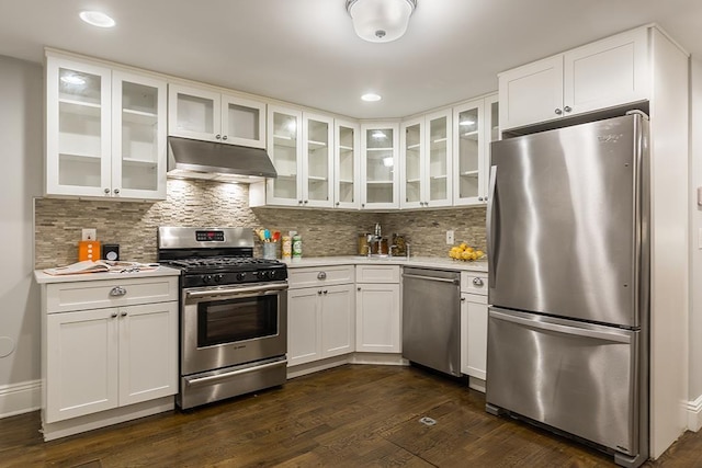 kitchen with dark wood-type flooring, white cabinets, and stainless steel appliances