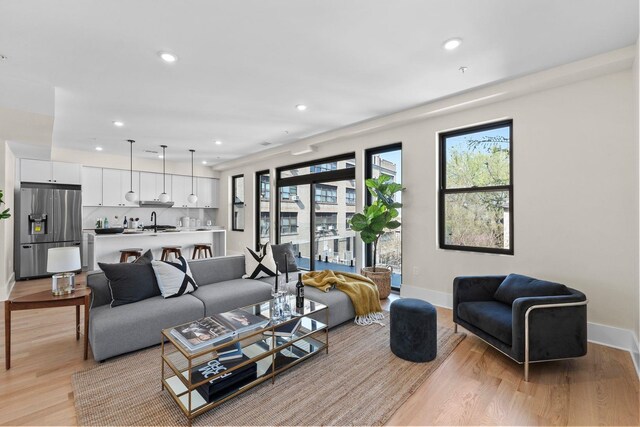 249 Bergen Ave Unit 201, Jersey City, NJ 07304 - living room with light wood-type flooring, baseboards, recessed lighting, and healthy amount of natural light