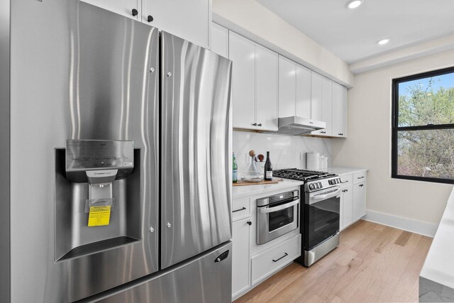 249 Bergen Ave Unit 201, Jersey City, NJ 07304 - kitchen with stainless steel appliances, light wood-style flooring, baseboards, light countertops, and white cabinets