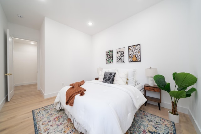 bedroom with recessed lighting, baseboards, and light wood-style floors