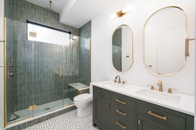 bathroom featuring a sink, toilet, double vanity, and a shower stall