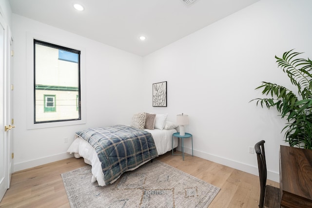 bedroom with recessed lighting, baseboards, and light wood finished floors