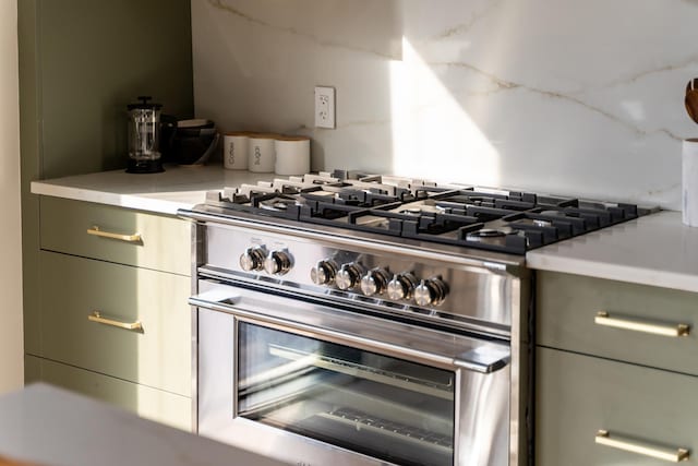 kitchen featuring high end stove and light countertops