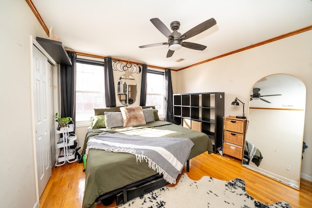 176 Webster Ave Unit 2L, Jersey City, NJ 07307 - bedroom featuring crown molding, light wood-style floors, a closet, and a ceiling fan