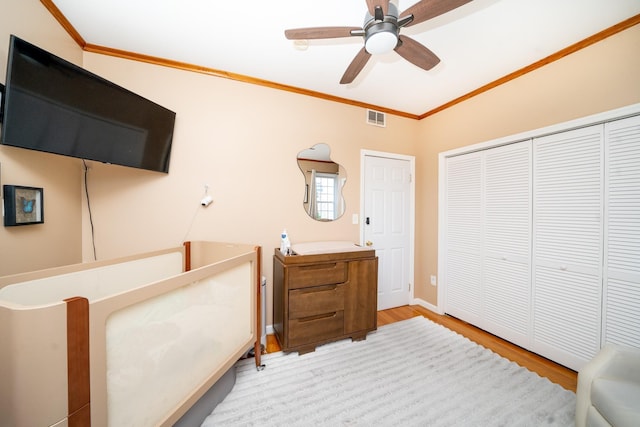 176 Webster Ave Unit 2L, Jersey City, NJ 07307 - bedroom with wood finished floors, a ceiling fan, a closet, crown molding, and visible vents