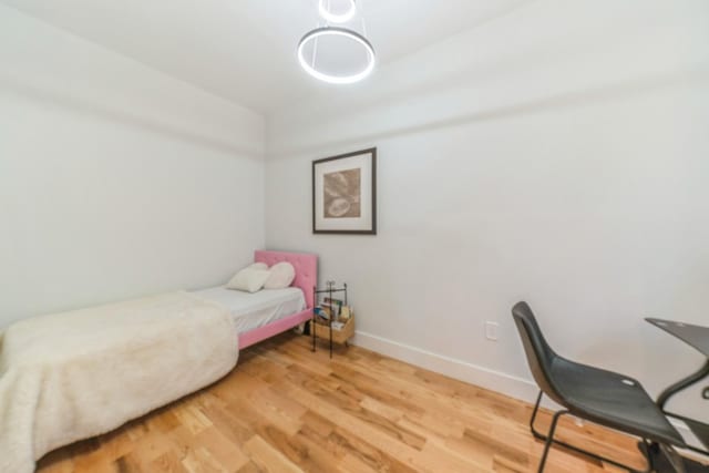 bedroom with wood-type flooring