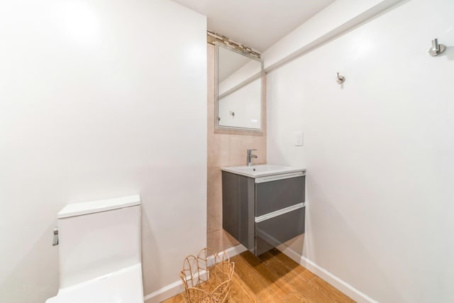 bathroom with vanity, hardwood / wood-style floors, and toilet