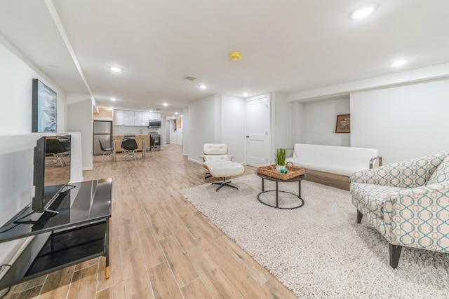 living room with light hardwood / wood-style flooring