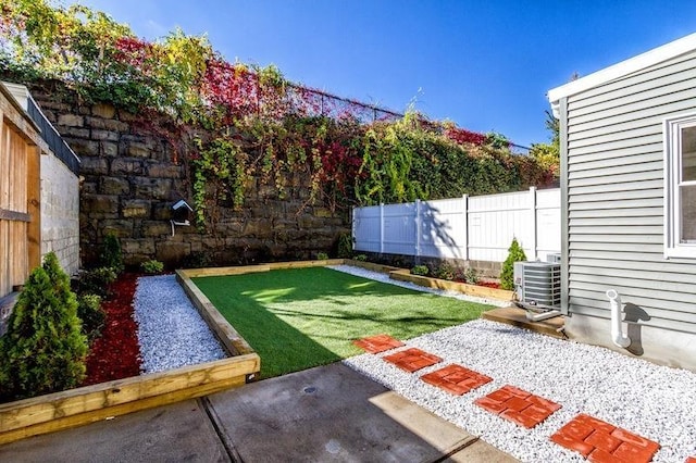 view of yard with cooling unit, a patio area, and a fenced backyard