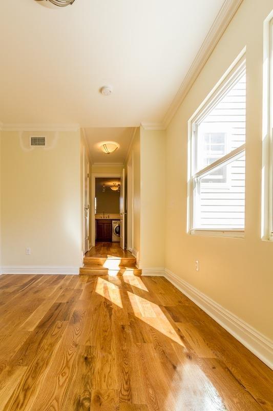 interior space with light wood finished floors, baseboards, and ornamental molding