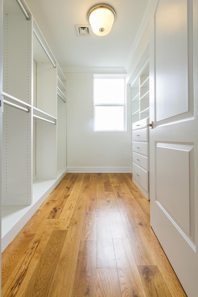 walk in closet featuring light wood finished floors and visible vents