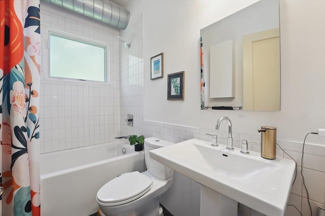 390 1st St Unit 2, Jersey City, NJ 07302 - bathroom with tile walls, a sink, shower / bath combination with curtain, and toilet