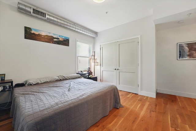 390 1st St Unit 2, Jersey City, NJ 07302 - bedroom featuring light wood-style flooring, a closet, and baseboards