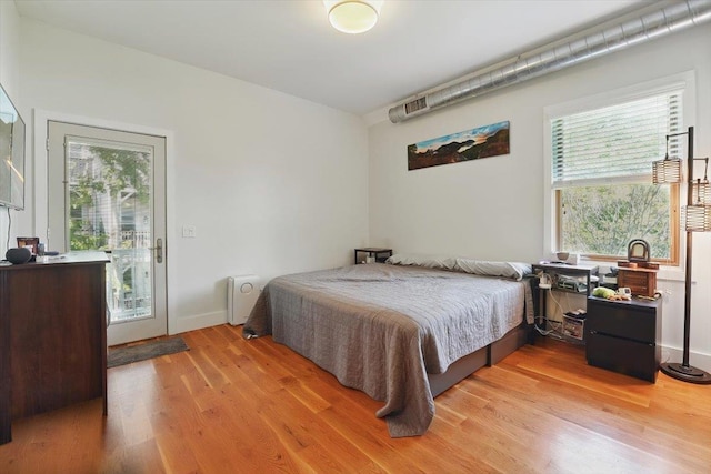 390 1st St Unit 2, Jersey City, NJ 07302 - bedroom featuring light wood finished floors, multiple windows, and access to outside